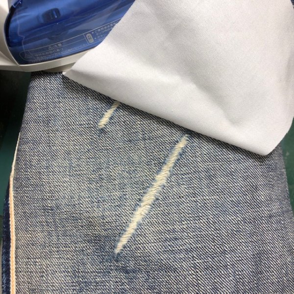 破れ目に芯地を貼り、さらにデニムで当て布を重ねます。